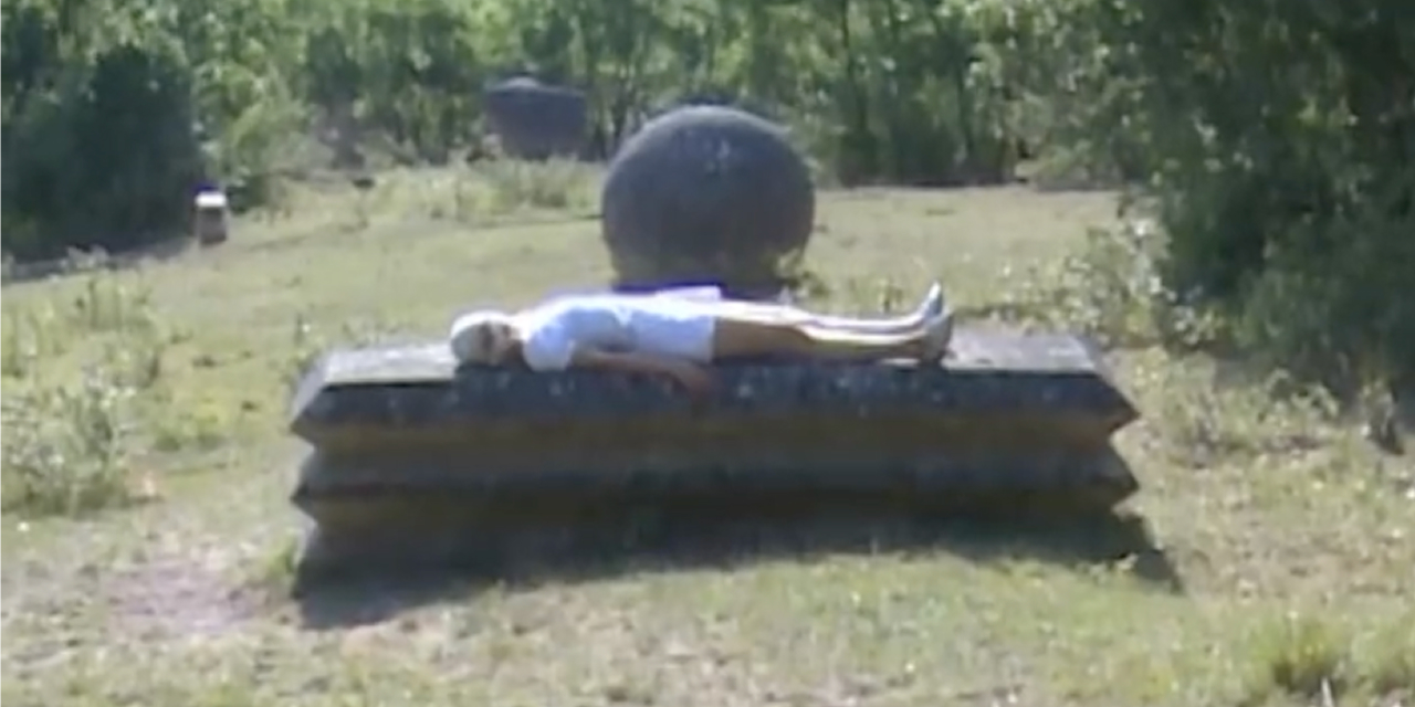 Figure resting in a garden